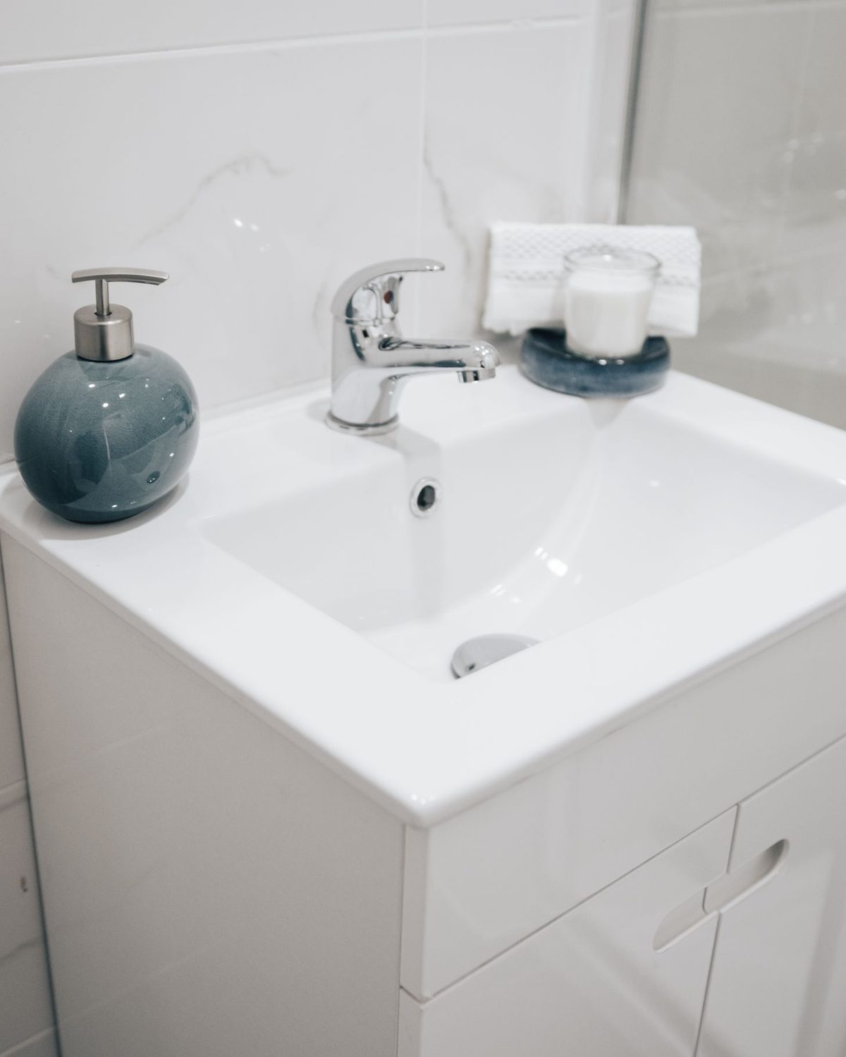 Modern chrome tap over a white sink